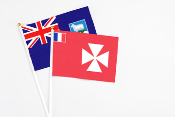 Wallis And Futuna and Falkland Islands stick flags on white background. High quality fabric, miniature national flag. Peaceful global concept.White floor for copy space.