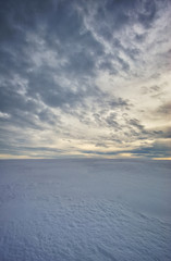 Fototapeta na wymiar winter field. picturesque sunset in a snowy field
