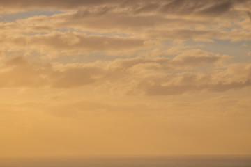 Beautiful and peaceful golden pastel sunset or sunrise over the ocean.