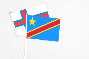 Congo and Faroe Islands stick flags on white background. High quality fabric, miniature national flag. Peaceful global concept.White floor for copy space.