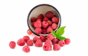 Mug with raspberries on white background. Mug with ripe raspberries on white background