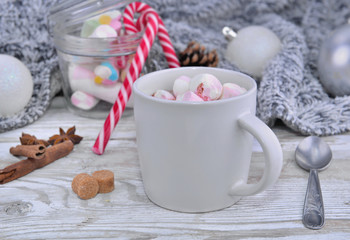 mug full of marshmallow on a table in christmas decoration
