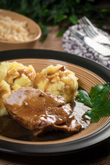 Braised pork neck in own sauce. Shallow depth of field.