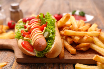 hot dog with french fries, sandwich with sausage, salad and sauce