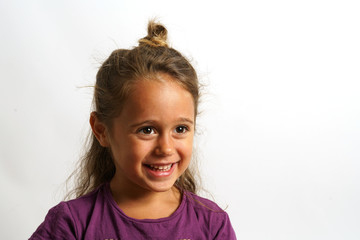 portrait on white background of a 4 year old Italian girl looking sideways