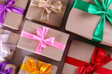 Simple composition with multiple presents wrapped in hand made blank craft paper gift wrap, pastel...