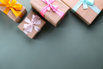 Simple composition with multiple presents wrapped in hand made blank craft paper gift wrap, pastel...