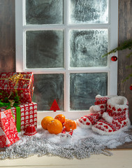 christmas concept with oranges with snow, wooden window background