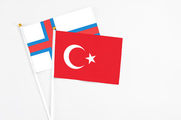 Turkey and Faroe Islands stick flags on white background. High quality fabric, miniature national flag. Peaceful global concept.White floor for copy space.