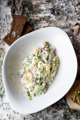Russian Olivier Salad with Meat, Pickles, Boiled Vegetables, Eggs and Mayonnaise Sauce
