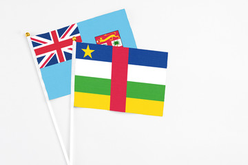 Central African Republic and Fiji stick flags on white background. High quality fabric, miniature national flag. Peaceful global concept.White floor for copy space.