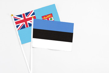 Estonia and Fiji stick flags on white background. High quality fabric, miniature national flag....