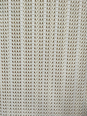 Plastic white wicker texture on laundry basket as clothing container, closeup on the pattern