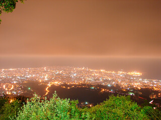 Fototapeta premium Night city background, beautiful urban cityscape, Beirut with street lights, high buildings and skyscrapers,panoramic dark town pattern, Middle East , Lebanon