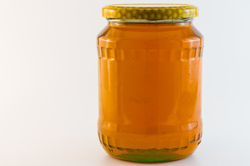 .glass jar with honey isolated