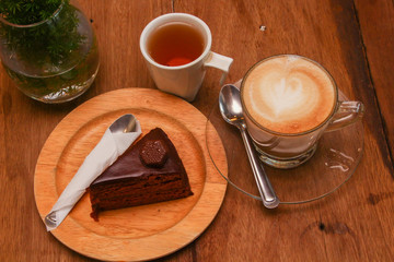 cup of coffee and cake on wooden table