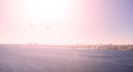 Fototapeta na wymiar Red bright sun over the plane and the river.