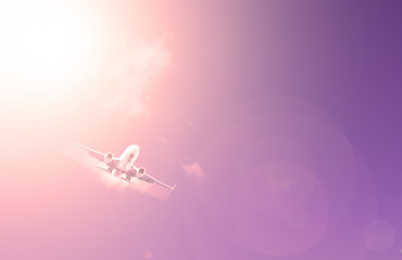 Airplane on sky background with sunset red.