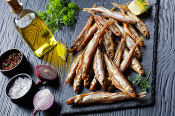 smoked smelts on a black slate tray