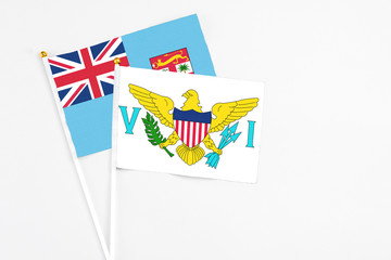 United States Virgin Islands and Fiji stick flags on white background. High quality fabric, miniature national flag. Peaceful global concept.White floor for copy space.