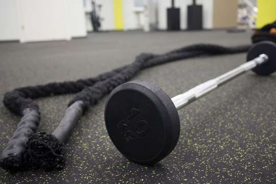 crossfit rope barbell and in the gym. Sports equipment on a black background. Motivation