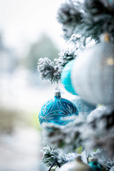 Christmas background. Detail view of blue and silver baubles and festive decorations hanging on a...