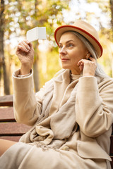 Fashionable attractive woman sitting on the bench