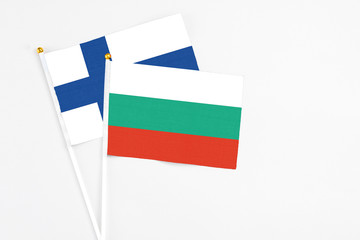 Bulgaria and Finland stick flags on white background. High quality fabric, miniature national flag. Peaceful global concept.White floor for copy space.