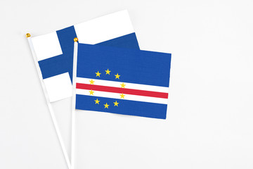 Cape Verde and Finland stick flags on white background. High quality fabric, miniature national flag. Peaceful global concept.White floor for copy space.