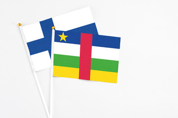 Central African Republic and Finland stick flags on white background. High quality fabric, miniature national flag. Peaceful global concept.White floor for copy space.