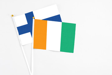 Cote D'Ivoire and Finland stick flags on white background. High quality fabric, miniature national...