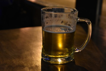 A glass of cold beer on the table