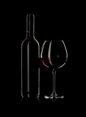 bottle and wine glass with red wine