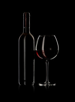 bottle and wine glass with red wine