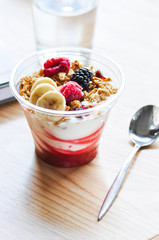 Overnight oatmeal with yogurt, banana slices and berries.