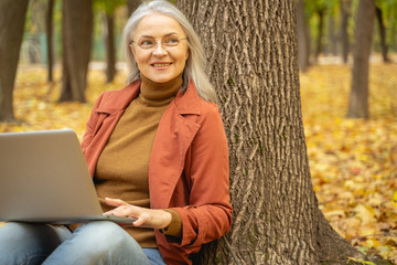 Happy woman working in a city park