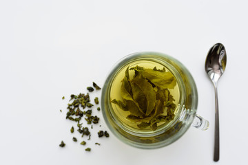 Green tea is brewed in a cup. Top view.