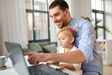 multi-tasking, freelance and fatherhood concept - working father with baby daughter and laptop...