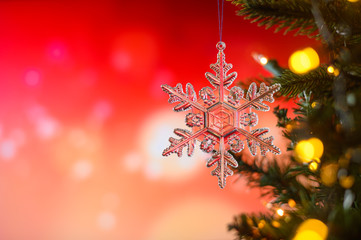 Christmas and background.Toy in the form of a transparent star on a Christmas tree, background for a card, dark red bokeh background, Greeting card for a congratulation for design. Inscription