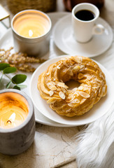 Simple real breakfast with coffee and custard cake on white plate