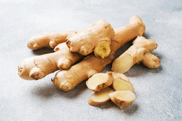 Fresh ginger root on grey background. Copy space.