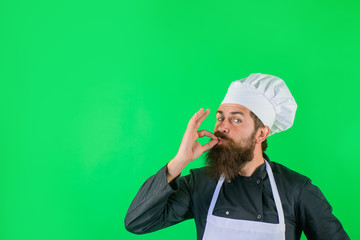 Professional chef showing delicious sign. Male chef in white uniform with perfect sign. Satisfied...