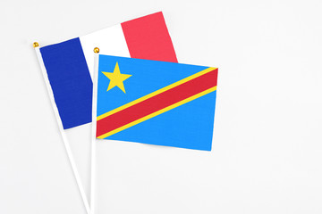 Congo and France stick flags on white background. High quality fabric, miniature national flag. Peaceful global concept.White floor for copy space.