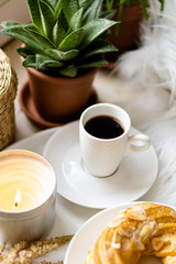 Simple real breakfast with coffee and custard cake on white plate