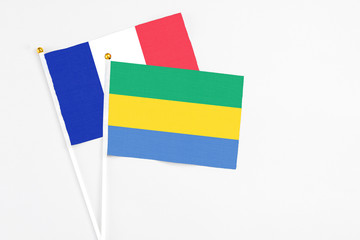 Gabon and France stick flags on white background. High quality fabric, miniature national flag....