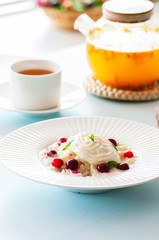 Rice porridge with milk and cranberry in a plate on a table.