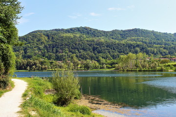 Fototapeta na wymiar Mountain view by Revine lake (landscape,sky,nature,blue,river,panorama,travel,reflection)