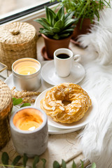 Simple real breakfast with coffee and custard cake on white plate