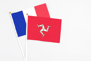 Isle Of Man and France stick flags on white background. High quality fabric, miniature national...