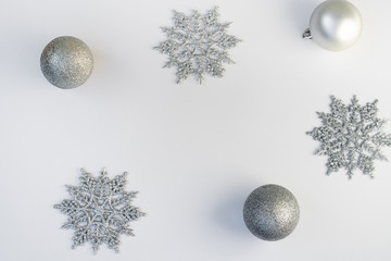 silver snowflakes with christmas decorations on a white background